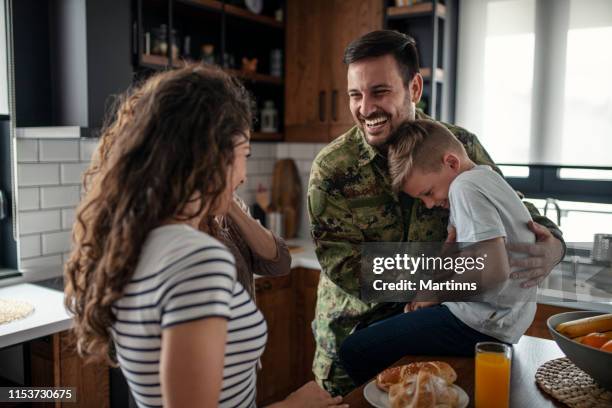 american soldier finally at home with his family - armed forces military family stock pictures, royalty-free photos & images