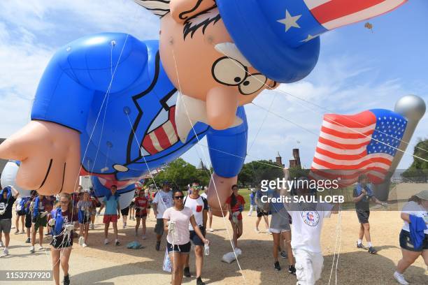 Participants pulls a balloon for the Independence Day parade in Washington, DC, on July 4, 2019.