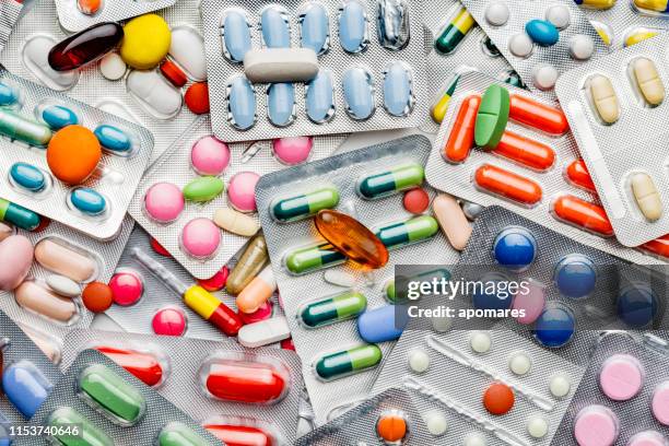 background of a large group of assorted capsules, pills and blisters - prescription medicine imagens e fotografias de stock