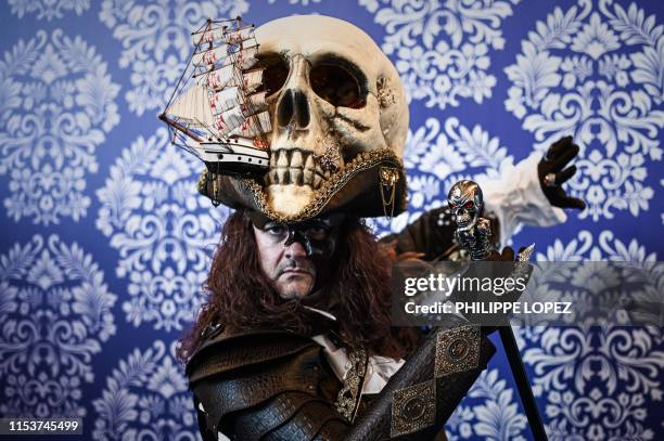 Cosplay participant wearing a hat made with a fake skull and a boat poses for a photo during the 2019 Japan Expo exhibition in Villepinte, near...