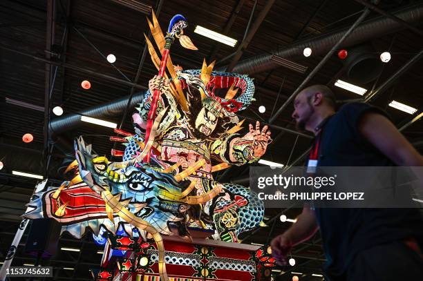 Man walks past an illuminated giant lantern at the 2019 Japan Expo exhibition in Villepinte, near Paris, on July 4, 2019. - Japan Expo, the largest...