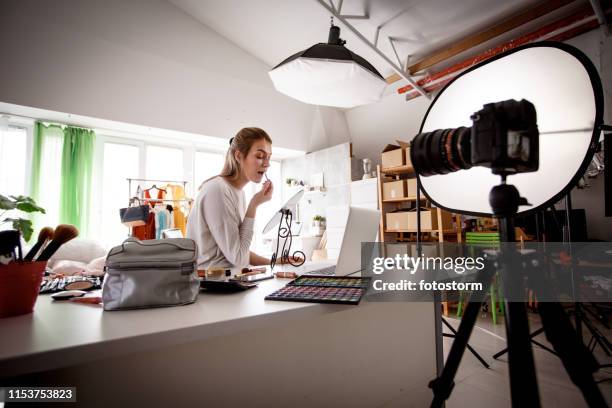 young woman blogger  recording video for her makeup channel - photo shoot set up stock pictures, royalty-free photos & images