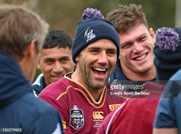 Cameron Smith of the Melbourne Storm laughs as he wears his Queensland Maroons jersey during a Melbourne Storm NRL training session at Gosch's...