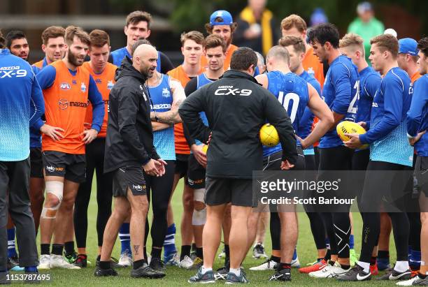 Interim coach of the Kangaroos Rhyce Shaw speaks to his team during a North Melbourne Kangaroos AFL training session at Arden Street Ground on June...