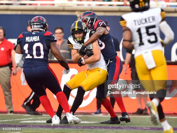 Tommie Campbell of the Montreal Alouettes grabs a hold of Jaelon Acklin of the Hamilton Tiger-Cats in the first half during the CFL game at Percival...