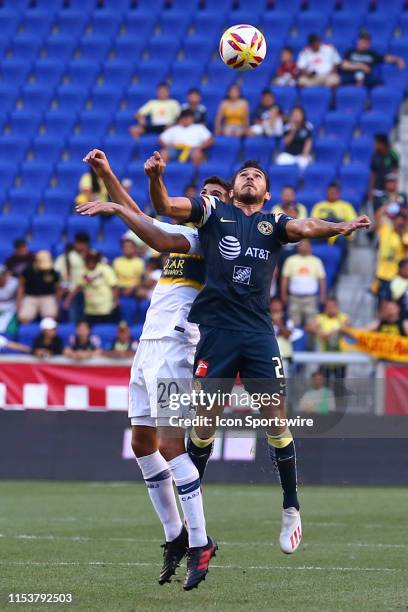 Club America forward Henry Martin heads the ball against Boca Juniors defender Lisandro Lopez during the first half of the Colossus Cup soccer match...