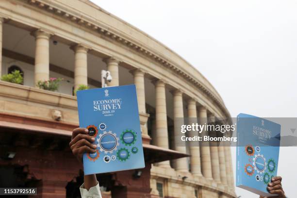 Copies of the Economic Survey 2018-19 is held up outside Parliament House in New Delhi, India, on Thursday, July 4, 2019. Newly appointed finance...