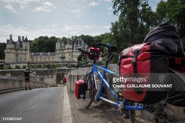 Couple of German cyclists stop on the road named "Loire a Velo", in front of the Chateau d'Usse, in Rigny-Usse, on July 2, 2019. "Loire a velo" is a...