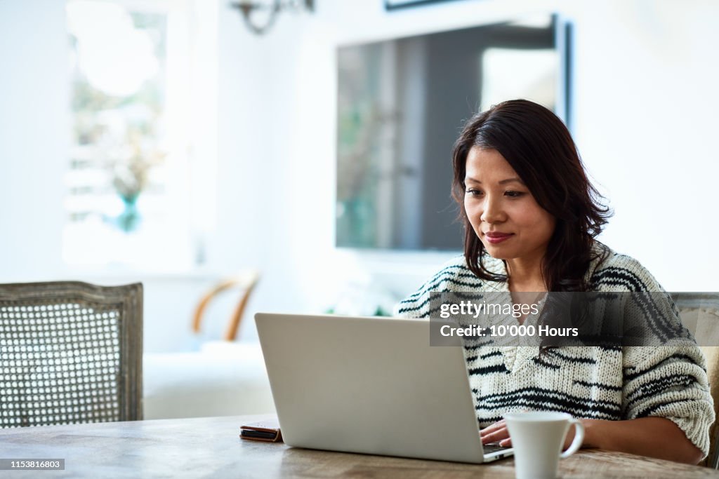 Woman using laptop and working from home