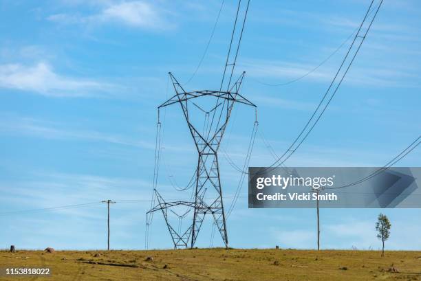 large power poles and lines across the countryside - electricity pylon stock pictures, royalty-free photos & images