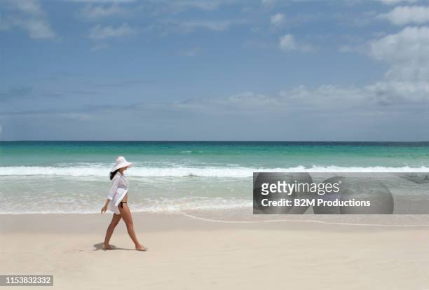young woman strolling on beach - kapverden stock-fotos und bilder