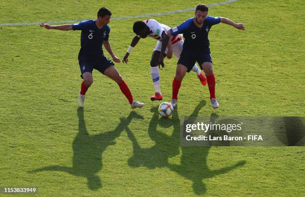 Enzo Loiodice and Amine Gouiri of France challenge Timothy Weah of USA during the 2019 FIFA U-20 World Cup Round of 16 match between France and USA...