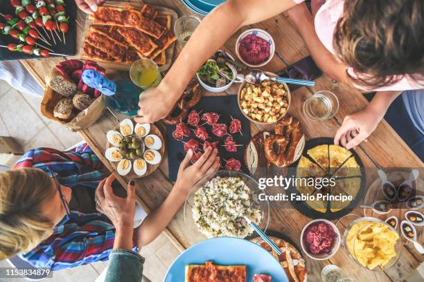 High Angle View Of People Having Food At Table In Restaurant