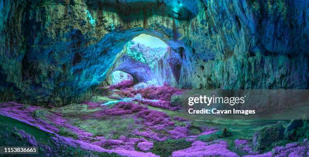 mystical cave in bright fantastic colors - cave entrance stock pictures, royalty-free photos & images