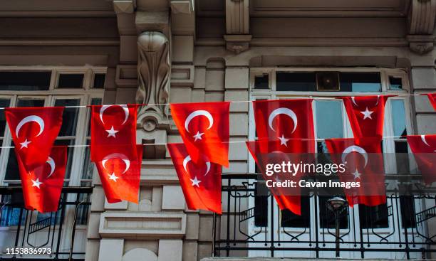 turkish national flags with white star and moon in sky - ankara fotografías e imágenes de stock