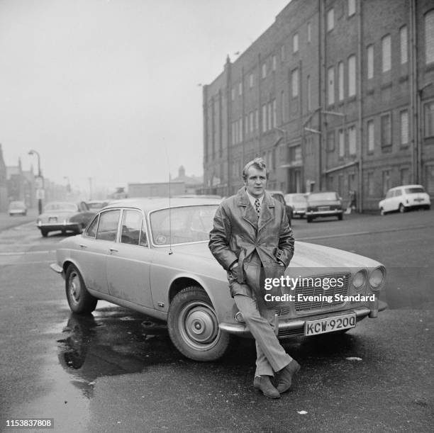 English soccer player Francis Lee of Manchester City FC near s Jaguar car, UK, 9th December 1969.