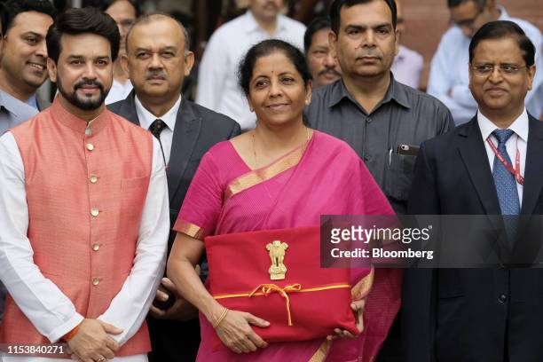 Nirmala Sitharaman, India's finance minister, center, Anurag Thakur, India's finance and corporate affairs minister, left, and other members of the...