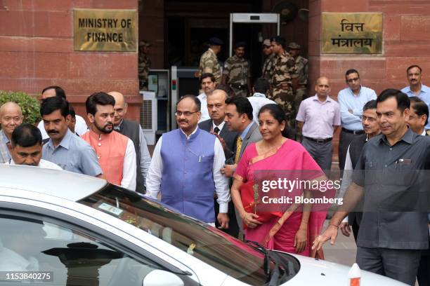 Nirmala Sitharaman, India's finance minister, center right, and other members of the finance ministry prepare to leave the North Block of the Central...
