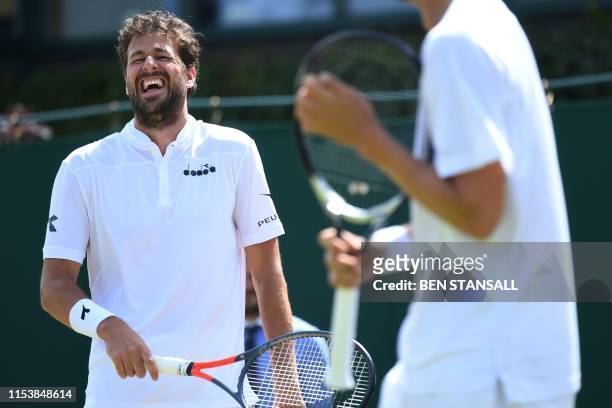 Netherlands' Robin Haase laughs with Denmark's Frederik Nielsen as they play Britain's Ken Skupski and Australian's John Patrick Smith during their...