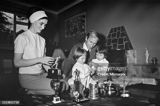 Manchester United's Bobby Charlton shows off his many trophies that he has won to his two children Andrea and Suzanne ay their home at Lymm,...