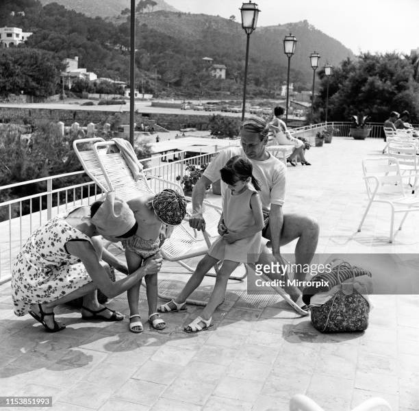 Bobby Charlton on holiday in Cala San Vicente, Majorca with his wife Norma and daughters Suzanne and Andrea. 12th June 1968.