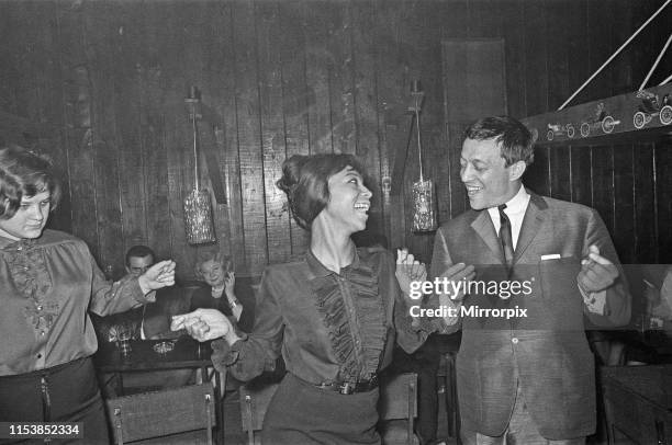 Playboy, film maker and night club owner Rolf Eden, seen here dancing with one of the patrons of his Old Eden Saloon night club. Circa 1965