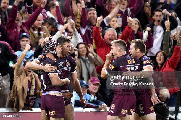 Kalyn Ponga, Corey Oates, Cameron Munster and Michael Morgan of the Maroons celebrate victory after game one of the 2019 State of Origin series...