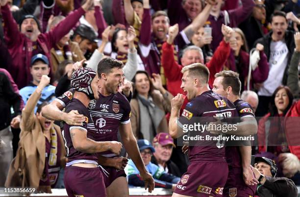 Kalyn Ponga, Corey Oates, Cameron Munster and Michael Morgan of the Maroons celebrate victory after game one of the 2019 State of Origin series...
