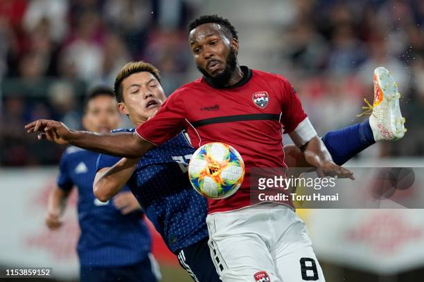 Ritsu Doan of Japan in action against Khaleem Hyland of Trinidad and Tobago during the international friendly match between Japan and Trinidad and...