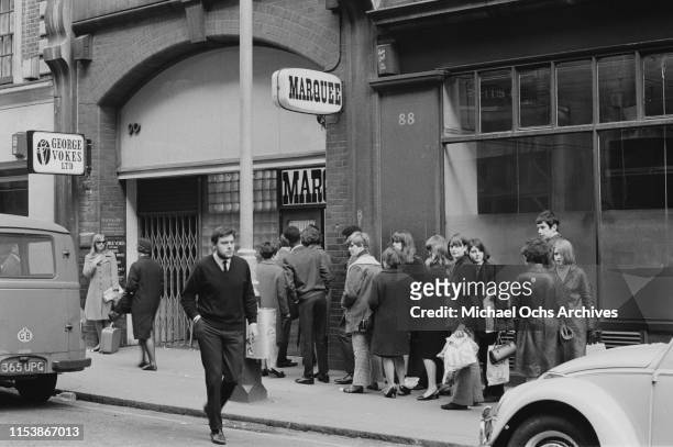 People queuing up outside the Marquee Club to attend the live concert of American rock band The Lovin' Spoonful, London, UK, 18th April 1966.
