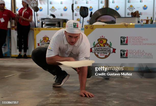 Maximiliano Mieres, winner of the free style contest and great winner of the pizza championship 2019, competes during the 'Pizza and Empanadas'...