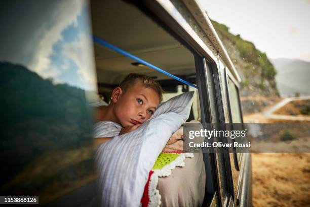 boy lying on mattress in off-road vehicle - corsica france stock pictures, royalty-free photos & images