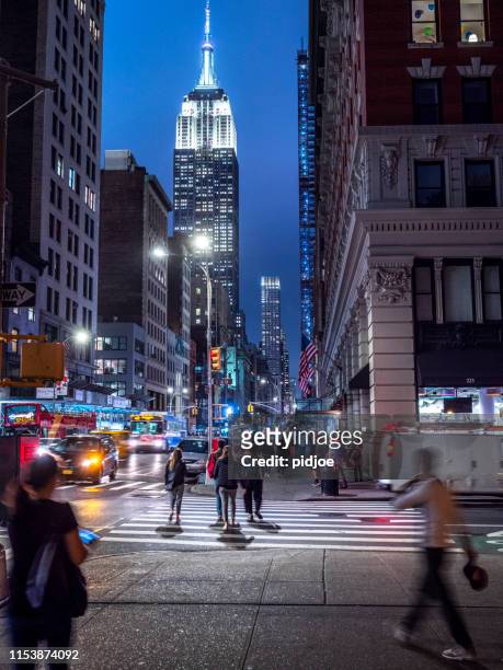 empire state building glowing at dusk - chrysler building stock pictures, royalty-free photos & images
