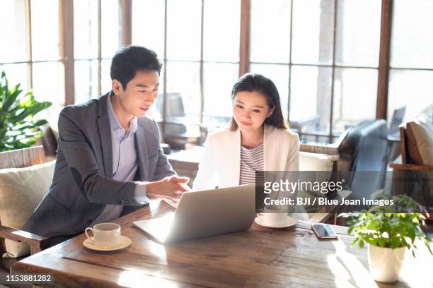 young business people talking in coffee shop - two executive man coffee shop stockfoto's en -beelden