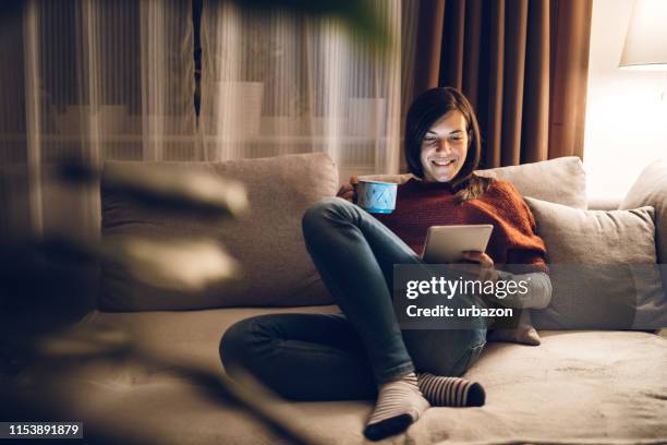 using digital tablet at night - living room night stock pictures, royalty-free photos & images