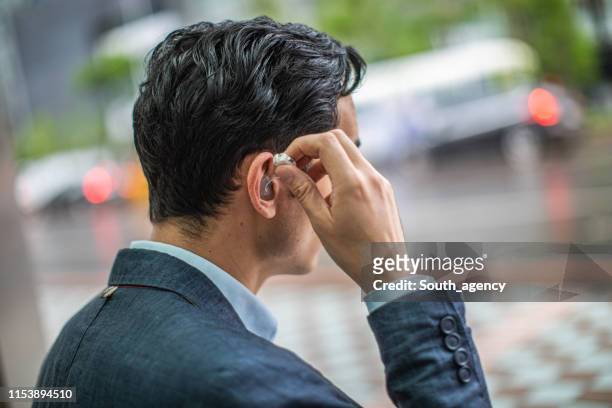 businessman in the city - hearing loss at work stock pictures, royalty-free photos & images
