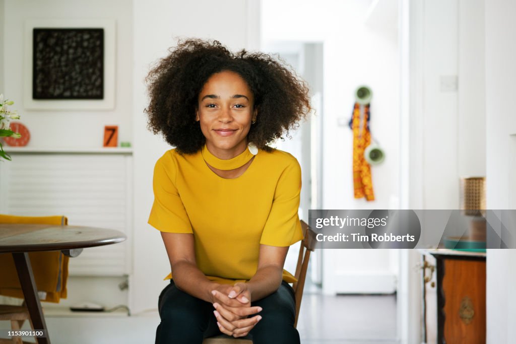 Woman sat on chair looking at camera