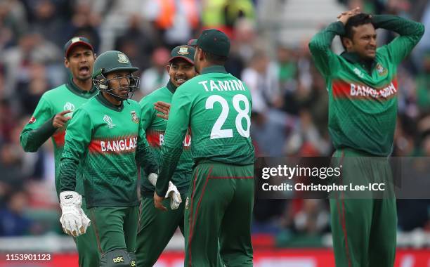 Wicket keeper Mushfiqur Rahim of Bangladesh talks to Tamin Iqbal Khan after he nearly runs out Kane Williamson of New Zealand during the Group Stage...