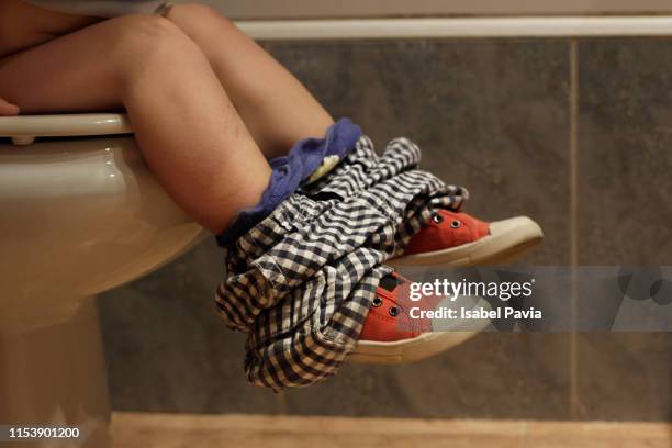 little boy sitting on toilet bowl in bathroom. potty training. - jupon photos et images de collection