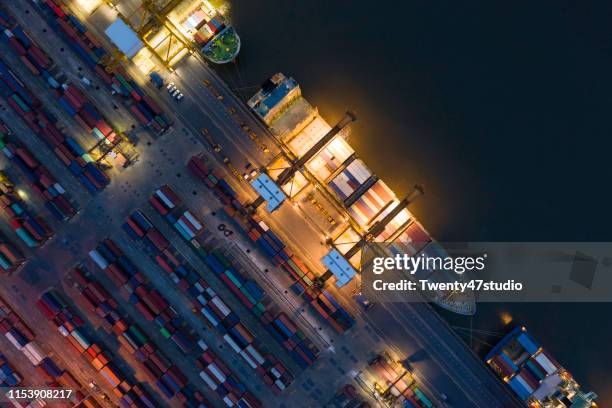 aerial view of logistic port with loading cranes and containers - docklands studio stock pictures, royalty-free photos & images