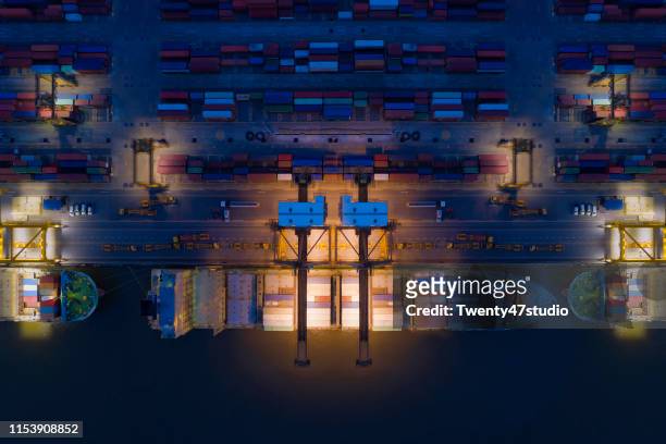aerial view of logistic port with loading cranes and containers - china ship stockfoto's en -beelden