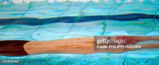 French swimmer Benjamin Stasiulis competes in the final of 200 m backstroke event on March 23, 2012 in Dunkerque, northern France, during the French...