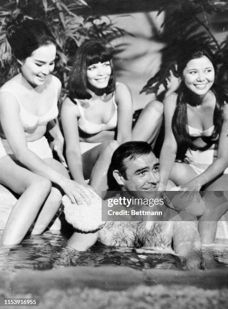 Actor Sean Connery has three good reasons to smile as he gets a soothing bath by three admiring beauties, from left, Mai line, Jeanne Roland, and Yee...