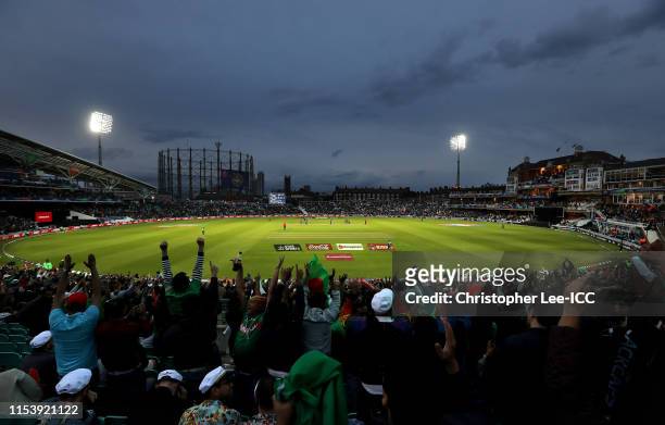 Bangladesh fans celebrate a wicket as the game is played under floodlights during the Group Stage match of the ICC Cricket World Cup 2019 between...
