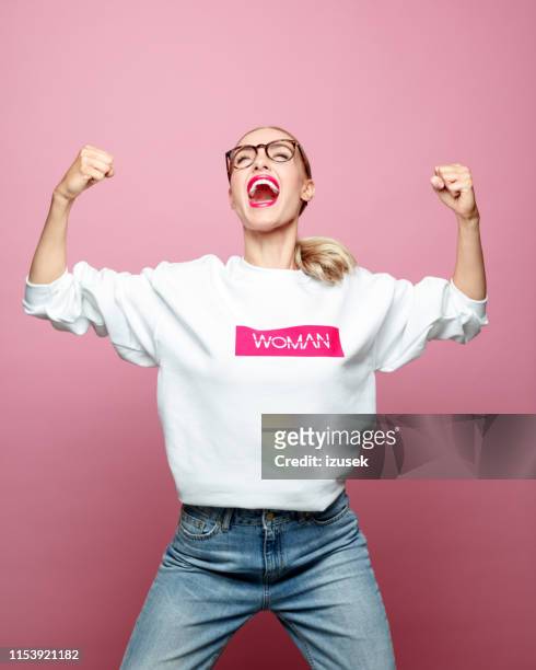 successful mid adult woman screaming - strength stock pictures, royalty-free photos & images