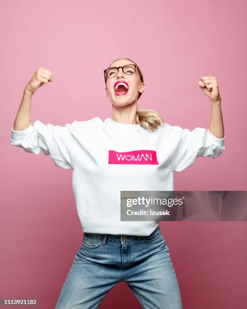 successful mid adult woman screaming - strong women stock pictures, royalty-free photos & images