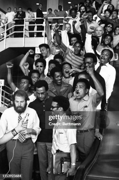 National Black Panther leaders, Huey Newton and David Hilliard are surrounded by supporters as Temple University law student, Steven Farber, leads...