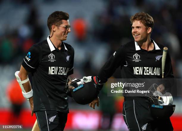 Mitchell Santner of New Zealand , who scored the winning run, celebrates with team mate Lockie Ferguson during the Group Stage match of the ICC...