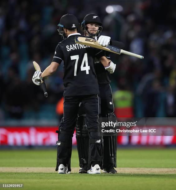 Mitch Santner and Lockie Ferguson of New Zealand celebrate their win during the Group Stage match of the ICC Cricket World Cup 2019 between...