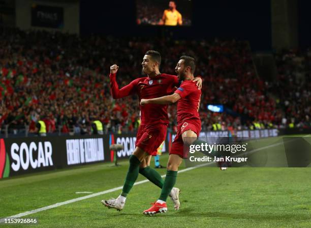 Cristiano Ronaldo of Portugal celebrates after scoring his team's second goal with Bernardo Silva during the UEFA Nations League Semi-Final match...